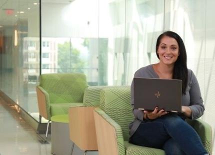 Female graduate student using laptop